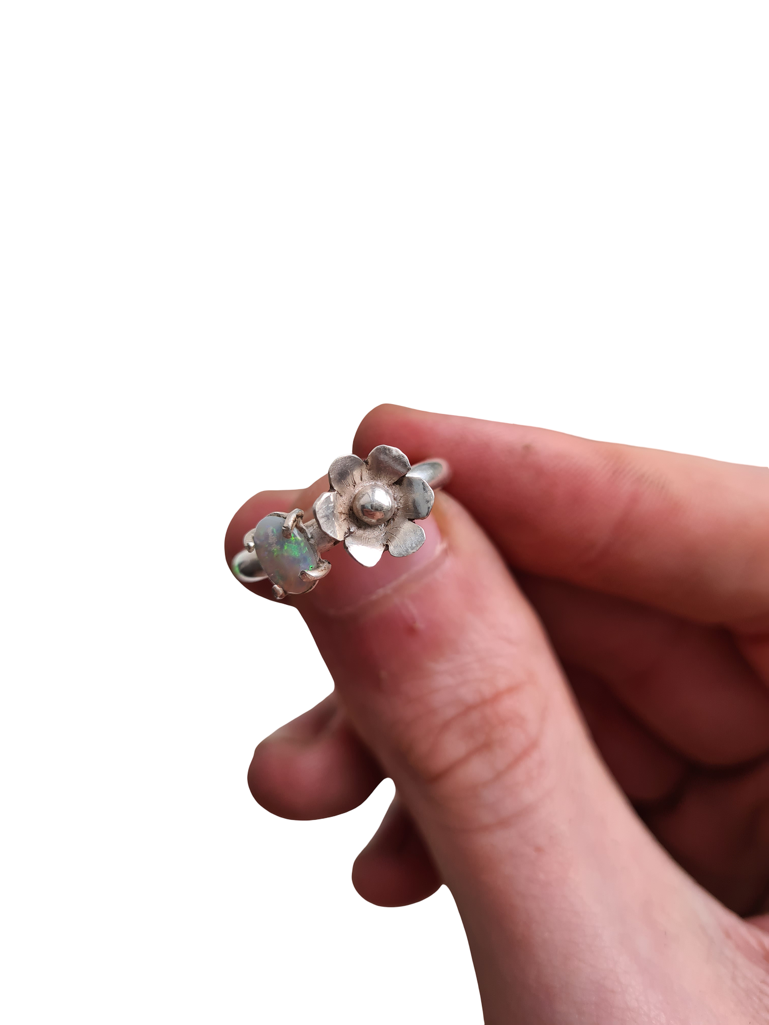 a ring with a blue green opal and a flower